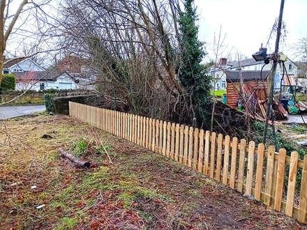 a_picket_fencing_installation_along_a_stream After